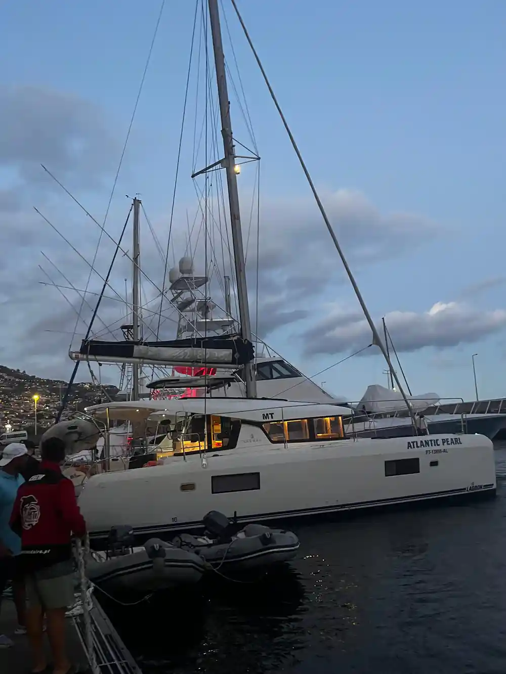 The Atlantic Pearl catamaran alongside in the marina at dusk