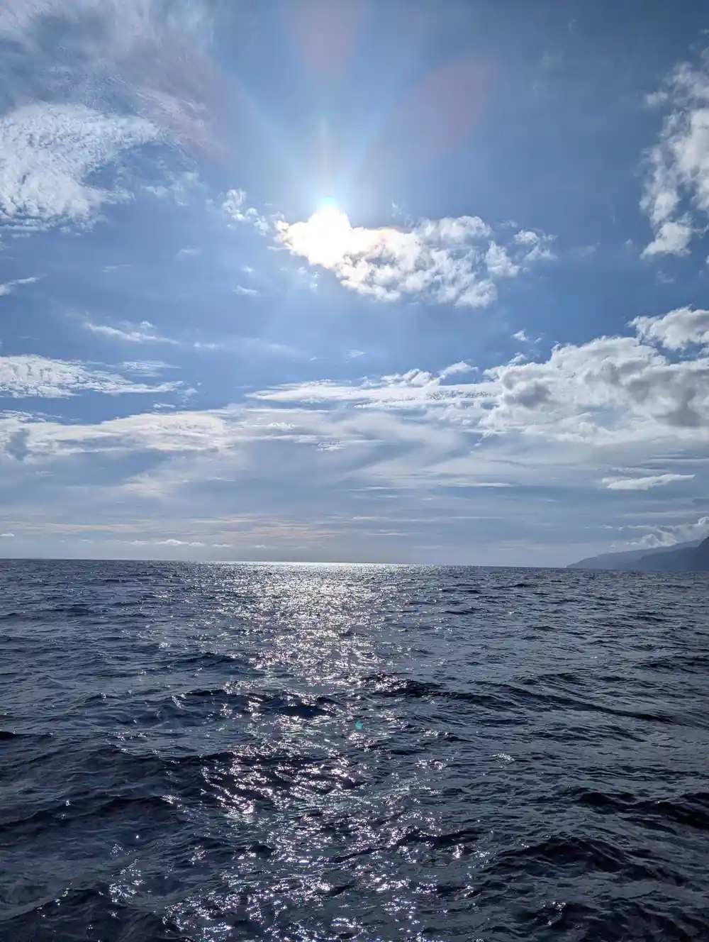 Bright cloud and sun over open water from the deck