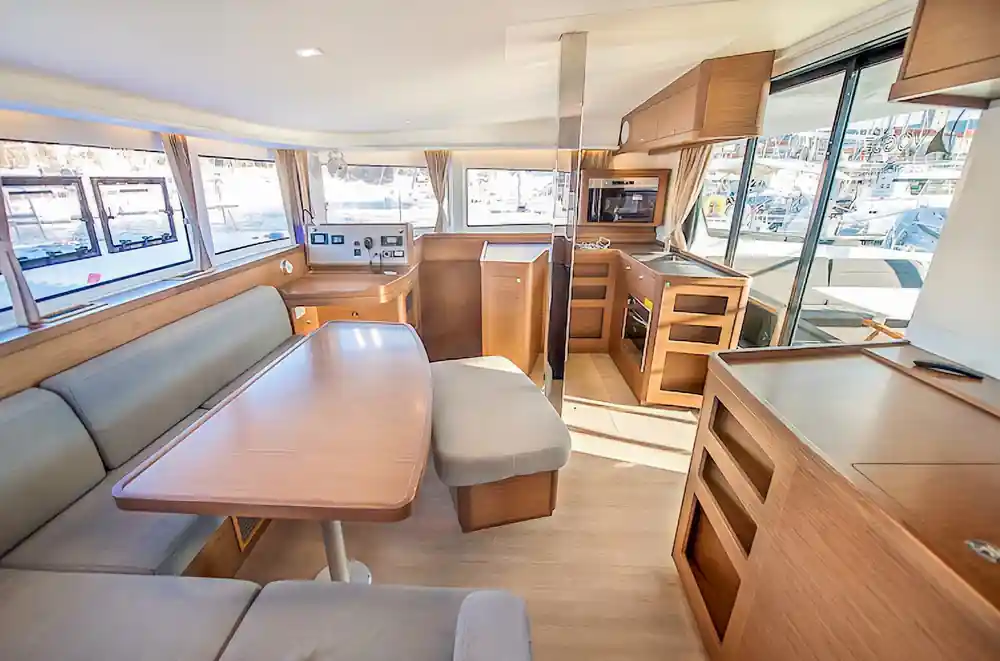The bright saloon interior with galley and panoramic windows