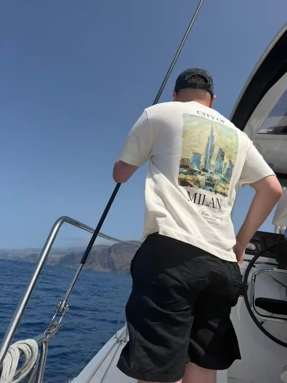 A crew member handling a line at the stern
