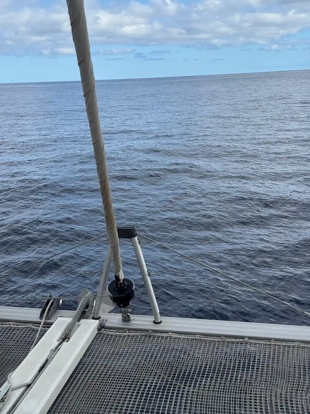 The foredeck nets and rail over calm open sea