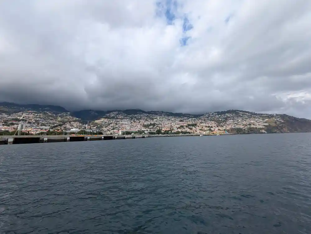 Funchal and its harbour seen from the water under cloud