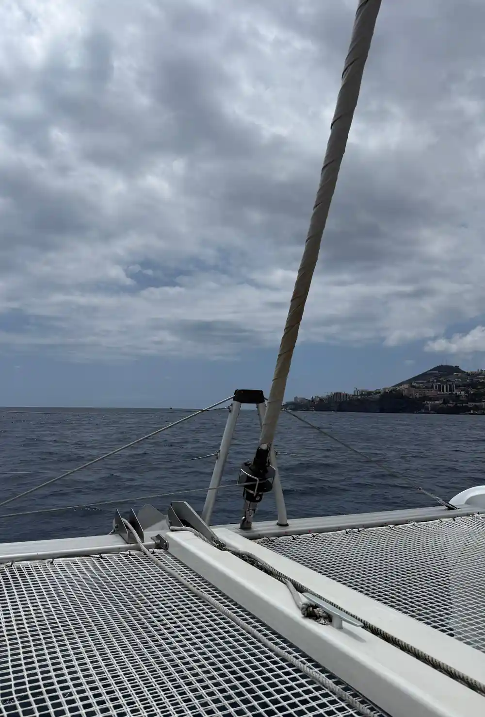 The mast and foredeck nets with the coast ahead