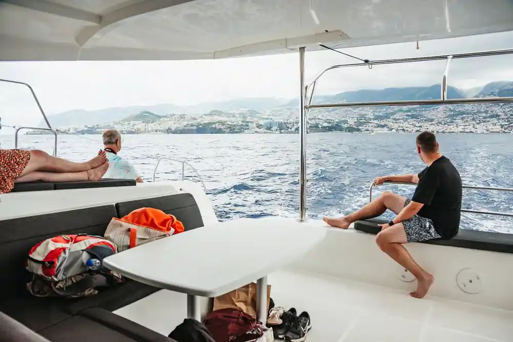 Passengers relaxing under the shaded cockpit awning under way