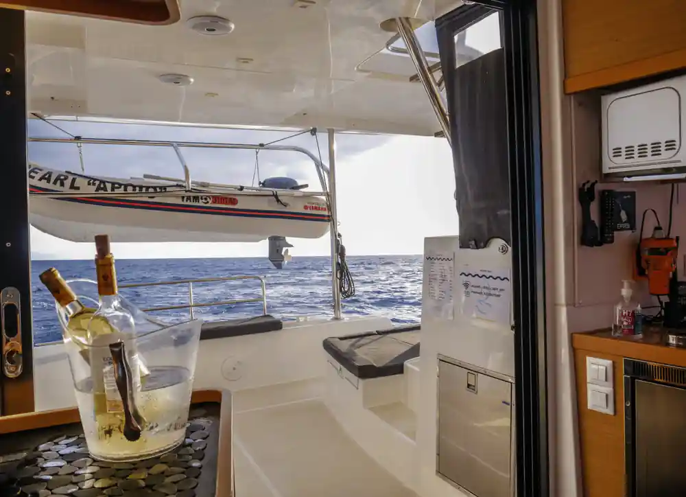 The shaded aft deck with a drinks table and the wake behind