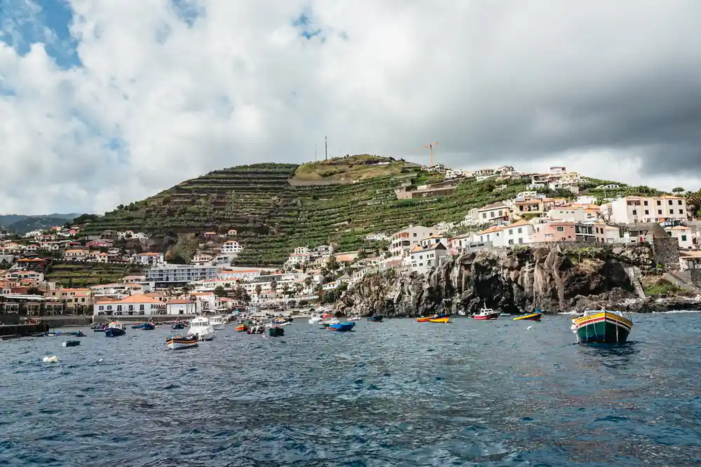 A terraced coastal village above a small harbour