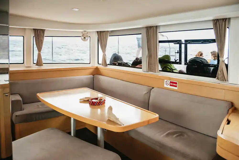 The wood-trimmed interior saloon with a table and bench seating